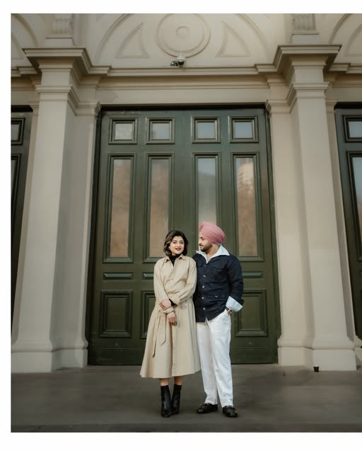 Couple photographed outside a grand doorway